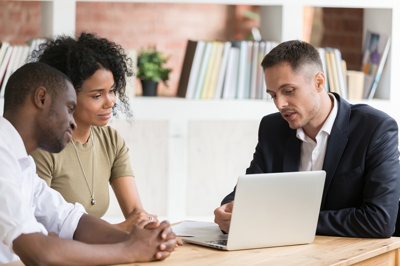 An Experienced Realtor Talking to Customers