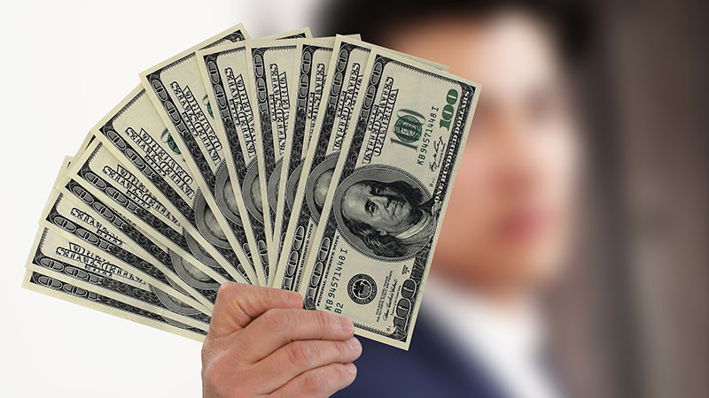 Photography of a Man Holding a Stack of Dollars