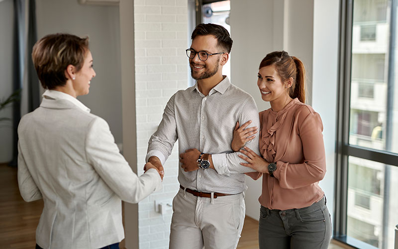 A Real Estate Agent Shaking Hands with Prospects