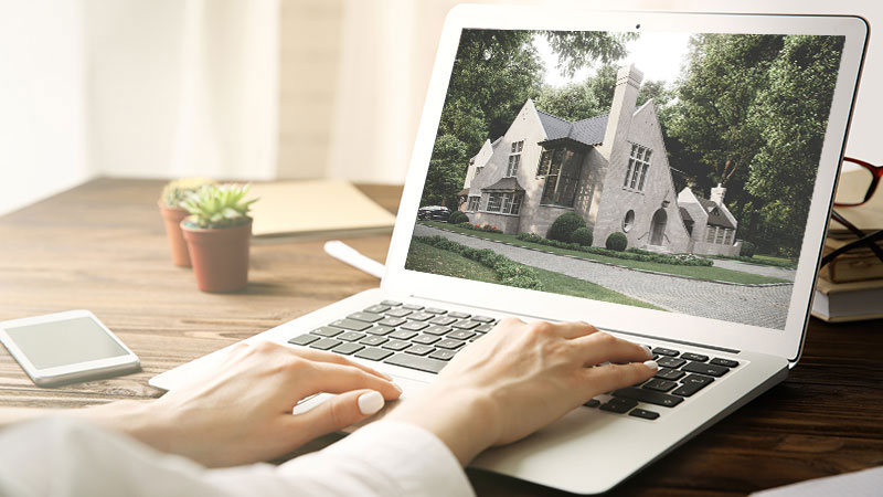 A Real Estate Agent Uploading CGI of a House to the Website